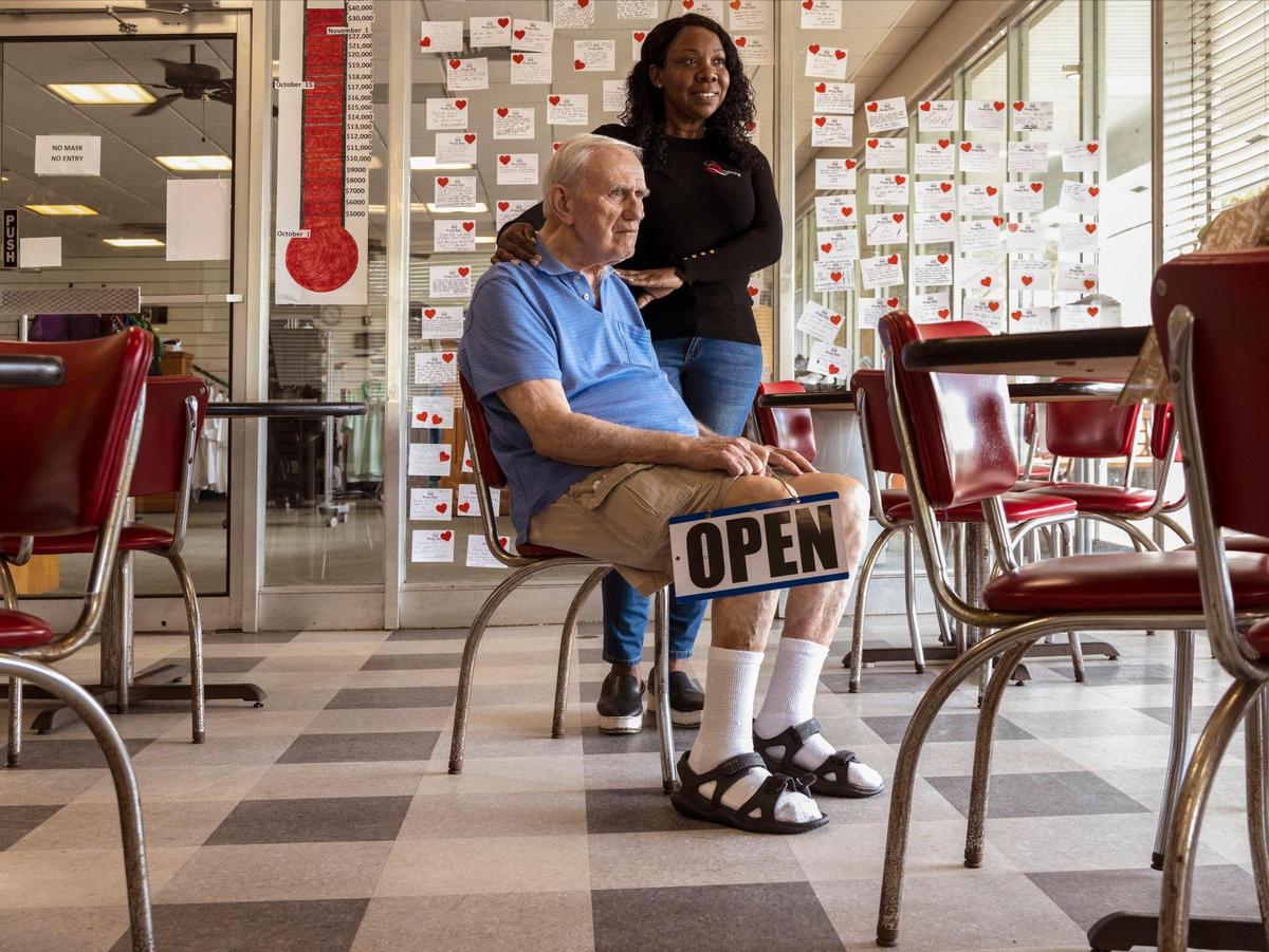 Bob Maguire, 85, left, and partner Rita Tennyson, right, are pictured at Burger Bob’s in Coral Gables on Dec. 20, 2021.