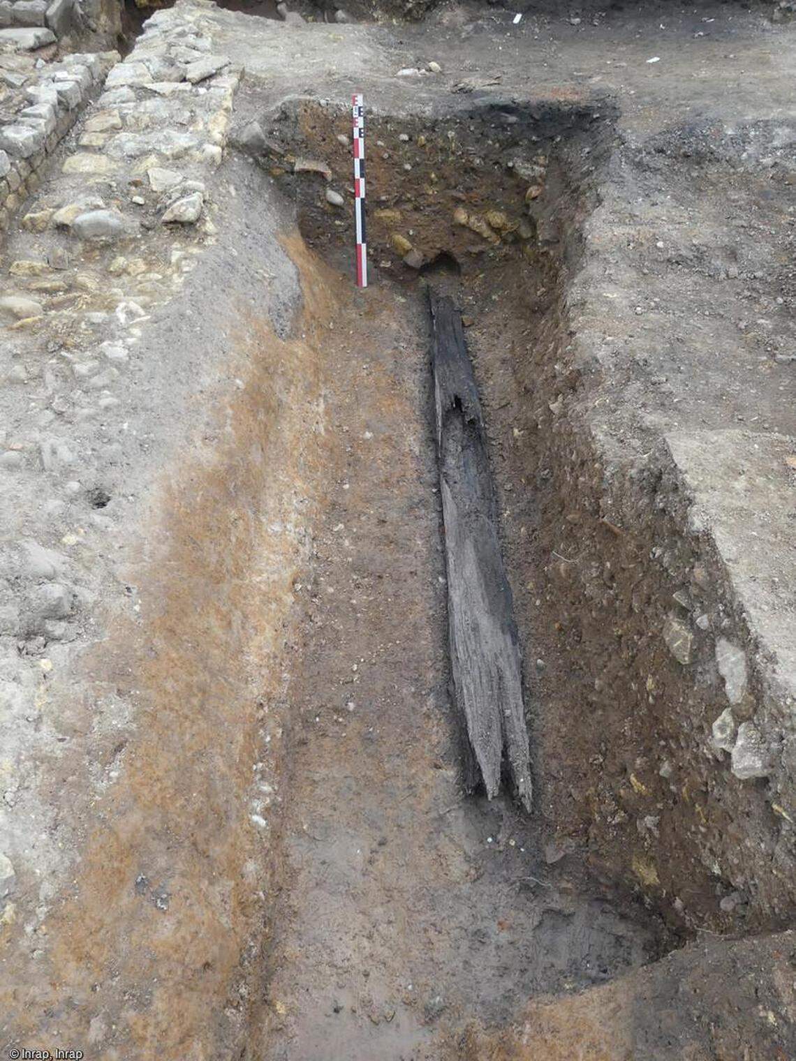 An ancient wooden pipe unearthed at the site.