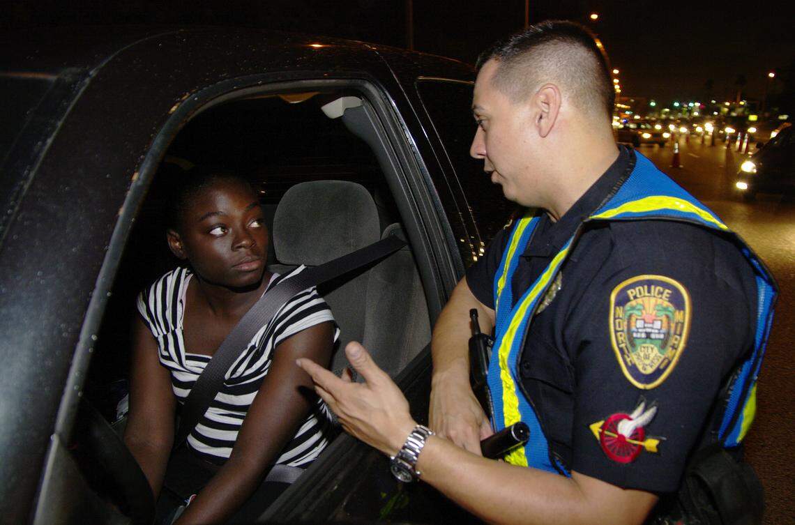 12/26/08-Officer Ray DeJesus Jr. tells Brittny Capron, 19, about the nights operation during a DUI checkpoint at Biscayne Blvd and 152nd Street in North Miami. CHRIS CUTRO / FOR THE MIAMI HERALD.