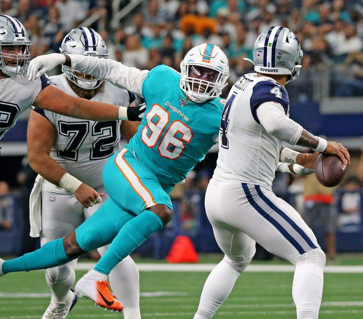 Miami Dolphins defensive end Taco Charlton (96) rushes Dallas Cowboys quarterback Day Prescott (4) in the second quarter at AT&T Stadium in Arlington, Texas, Sunday, September, 22, 2019.