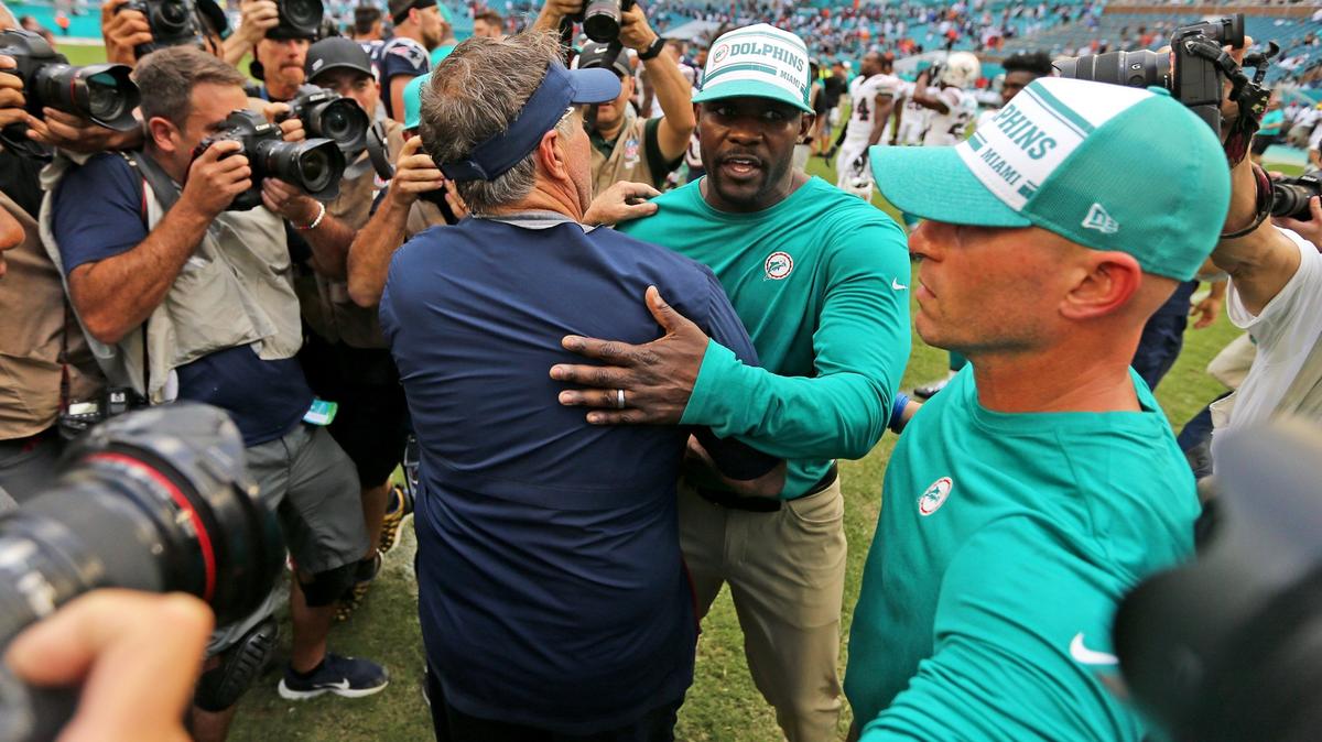 New England Patriots Bill Belichick hugs Miami Dolphins head coach Brian Flores after an NFL football game at Hard Rock Stadium on Sunday, September 15 2019, in Miami Gardens. Patriots won 43-0.
