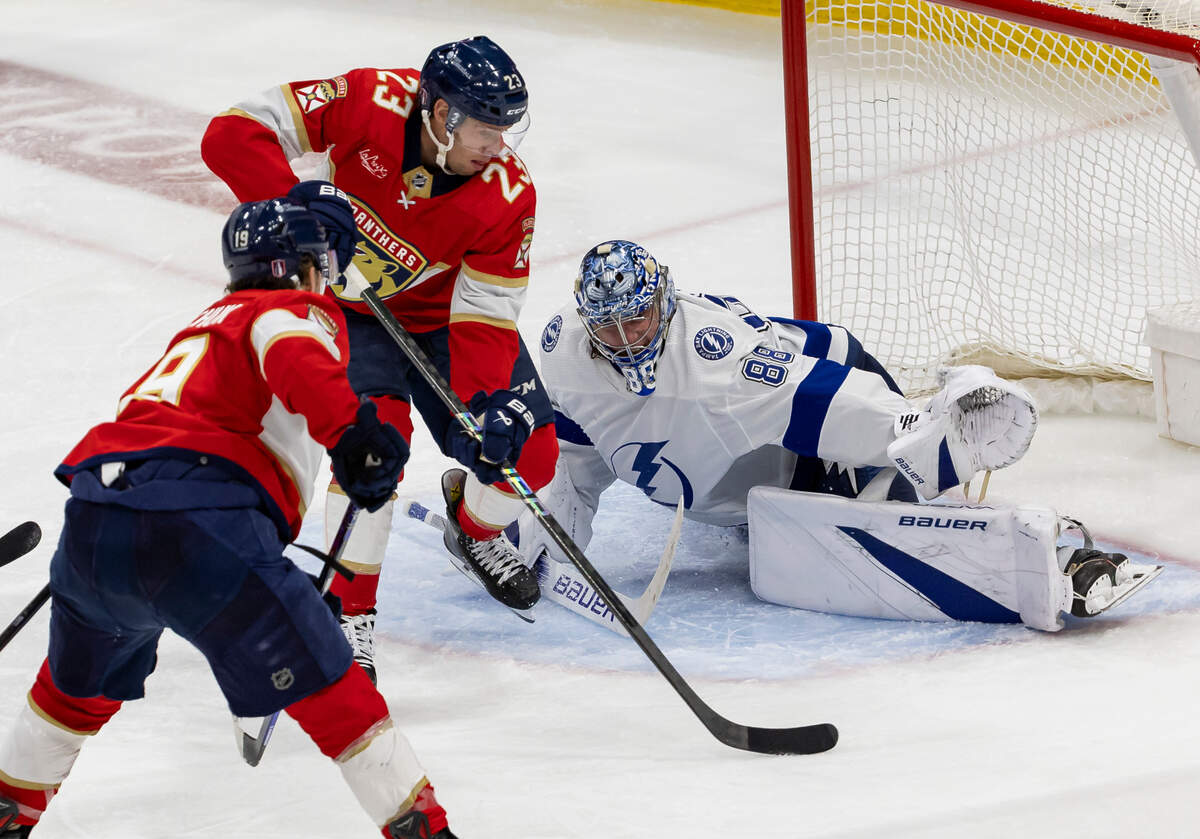 Florida Panthers center Carter Verhaeghe (23) scores a goal against Tampa Bay Lightning goaltender Andrei Vasilevskiy (88) in overtime period in Game 2 of the first-round of the 2024 Stanley Cup Playoffs at Amerant Bank Arena on Tuesday, April 23, 2024, in Sunrise, Fla.