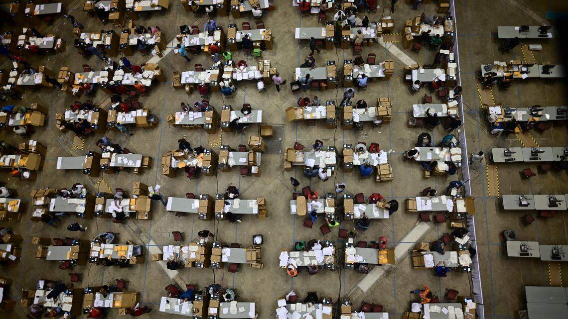 Officials count early votes at the Roberto Clemente Coliseum, where they can social distance during the COVID-19 pandemic, during the general elections in San Juan, Puerto Rico, on Tuesday, November 3, 2020. In addition to choosing a governor, Puerto Ricans voted in a non-binding plebiscite for the island’s statehood.