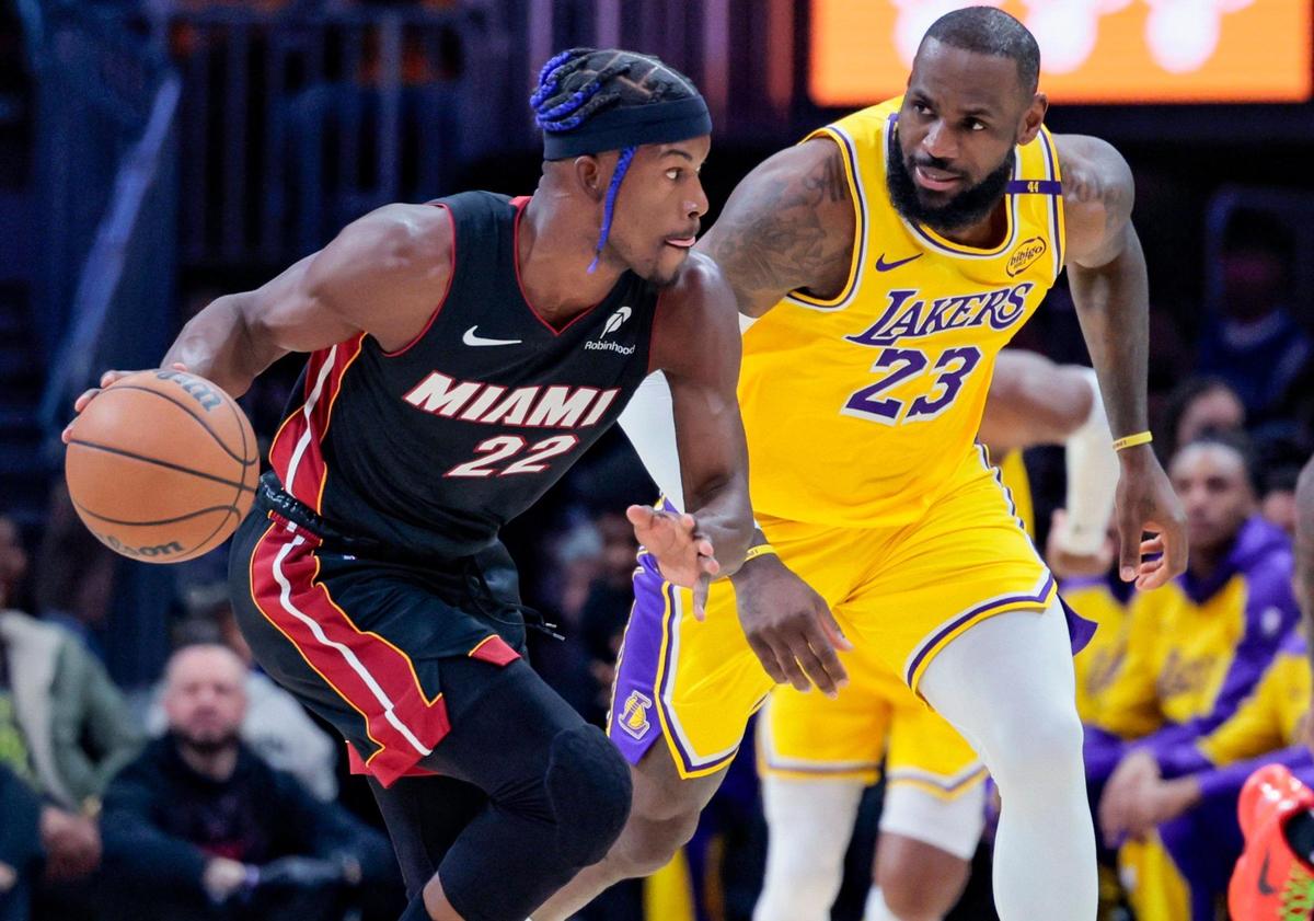 Miami Heat forward Jimmy Butler (22) drives the ball as Los Angeles Lakers forward LeBron James (23) gives chase in the first half of their NBA game at Kaseya Center in Miami on December 4, 2024.