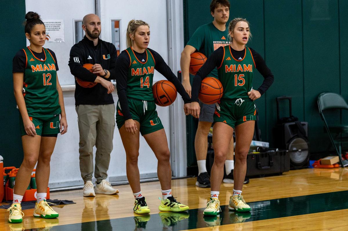 Miami Hurricanes twin guards Haley Cavinder (14) and Hanna Cavinder (15) look on during practice at Watsco Center on Thursday, September 26, 2024, in Coral Gables, Fla.