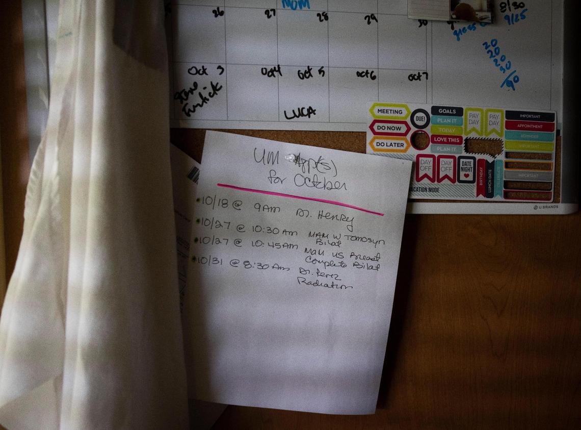 One of the multiple reminders about breast cancer appointments is posted in Isabel Toca’s home on Wednesday, Oct. 4, 2023, in Miami, Fla. Toca takes an estrogen suppressant which has a lot of negative side effects including brain fog, so she has to have multiple reminders about important meetings. “Cancer changes a lot with the people around you,” said Toca.