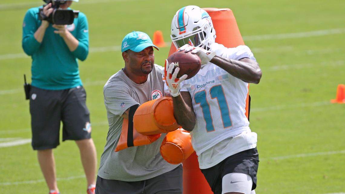 Dolphins receiver DeVante Parker, shown practicing last month, is not pleased with what he's hearing from Chris Chambers.
