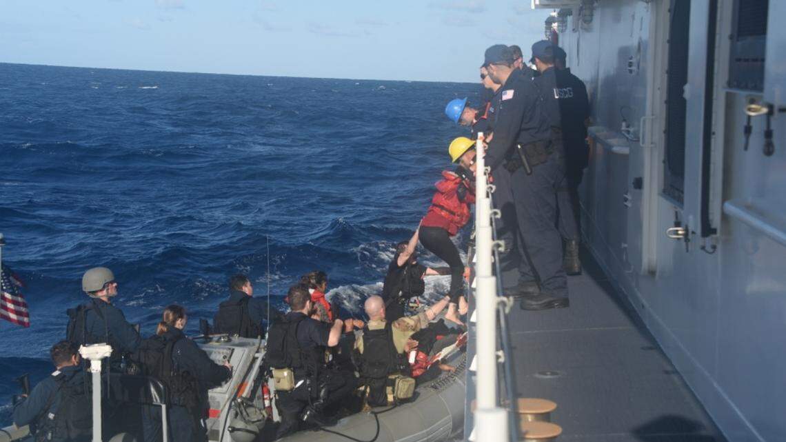 The crew of the Coast Guard Cutter Charles Sexton takes 26 migrants on board who were caught about 50 miles from the coast of Long Key Tuesday, March 12, 2019.
