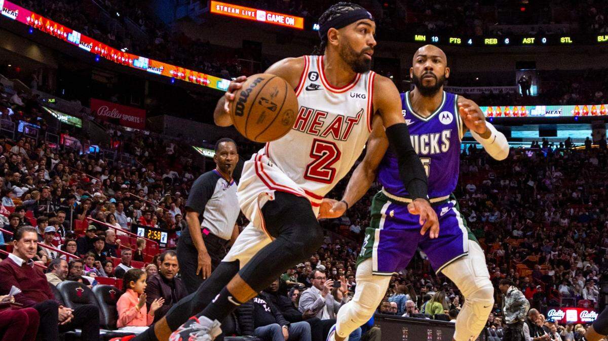 Miami Heat point guard Gabe Vincent (2) drives on Milwaukee Bucks guard Jevon Carter (5) during the second half of an NBA game at Miami-Dade Arena in Downtown Miami on Saturday, January 14, 2023.