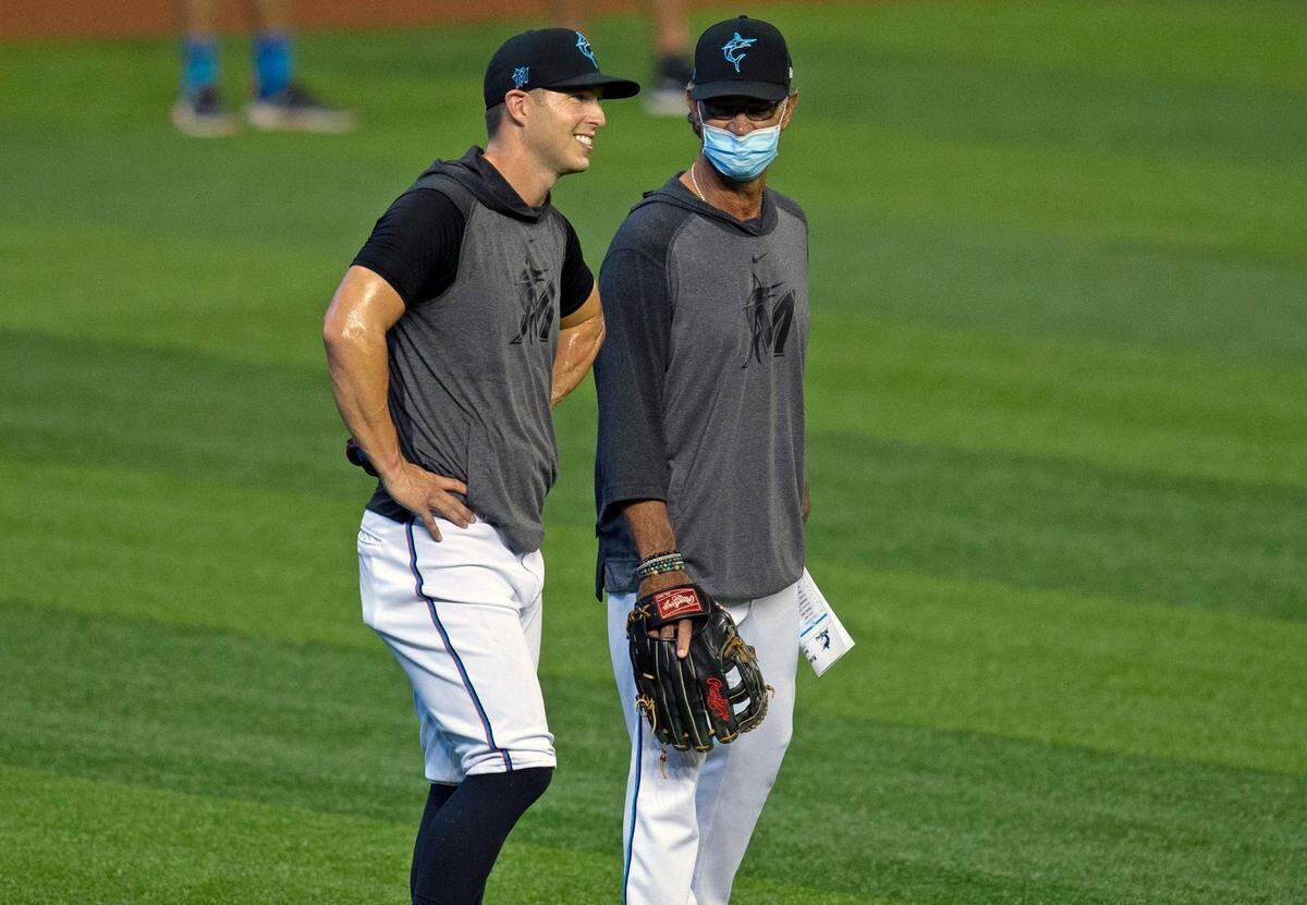 Miami Marlins designated hitter Corey Dickerson talks with Miami Marlins manager Don Mattingly before the start of a baseball game against the New York Mets at at Marlins Park in Miami on Tuesday, Aug. 18, 2020.