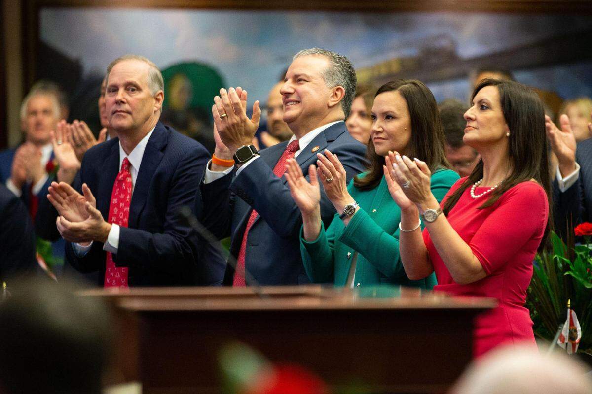 Commissioner of Agriculture Wilton Simpson, left, CFO Jimmy Patronis, Attorney General Ashley Moody and Lt. Gov. Jeanette Nuñez applaud Gov. DeSantis during his State of the State Address on opening day of the 2023 Florida Legislative Session on March 7.