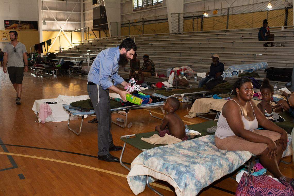 Rabbi Sholom Bluming delivers a toy to a child in Freeport in the days after Hurricane Dorian hit the island nation on Sept. 1.