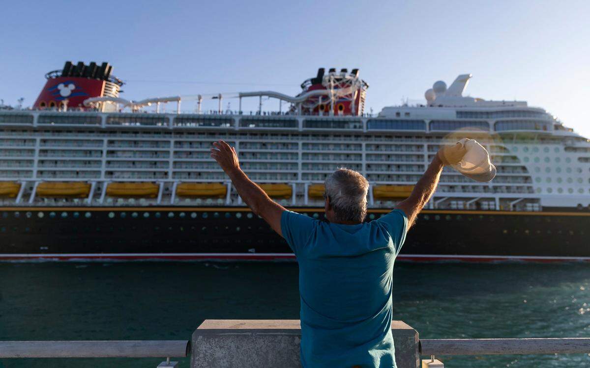Giwrgos Telwnis, from Greece, waves as a Disney Cruise Line leaves PortMiami near South Pointe Park on Monday, Feb. 27, 2023, in Miami Beach, Fla. Forecasters expect temperatures to be around 90 degrees this week across South Florida.