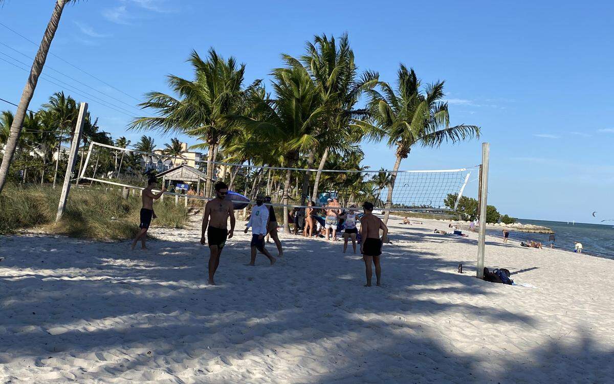 A group plays volleyball at Smathers Beach in Key West, the day after the city reopened its beaches to locals after a six-week shutdown due to the COVID-19 pandemic.
