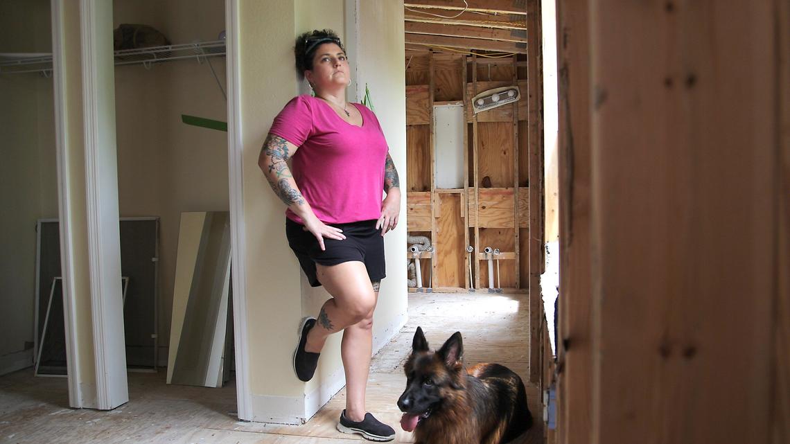 
On Thursday, August 30, 2018 Key Largo resident Melinda Goodro and her wife, are having a tough time getting paid by Citizens Insurance after damages from Hurricane Irma nearly a year ago. Goodro is photographed inside her damaged third floor bedroom with her dog “Qynn.” She is still living in her RV a year later. Her three-story home suffered heavy roof and water damage and repairs can not be made until insurance claim has been resolved. 
