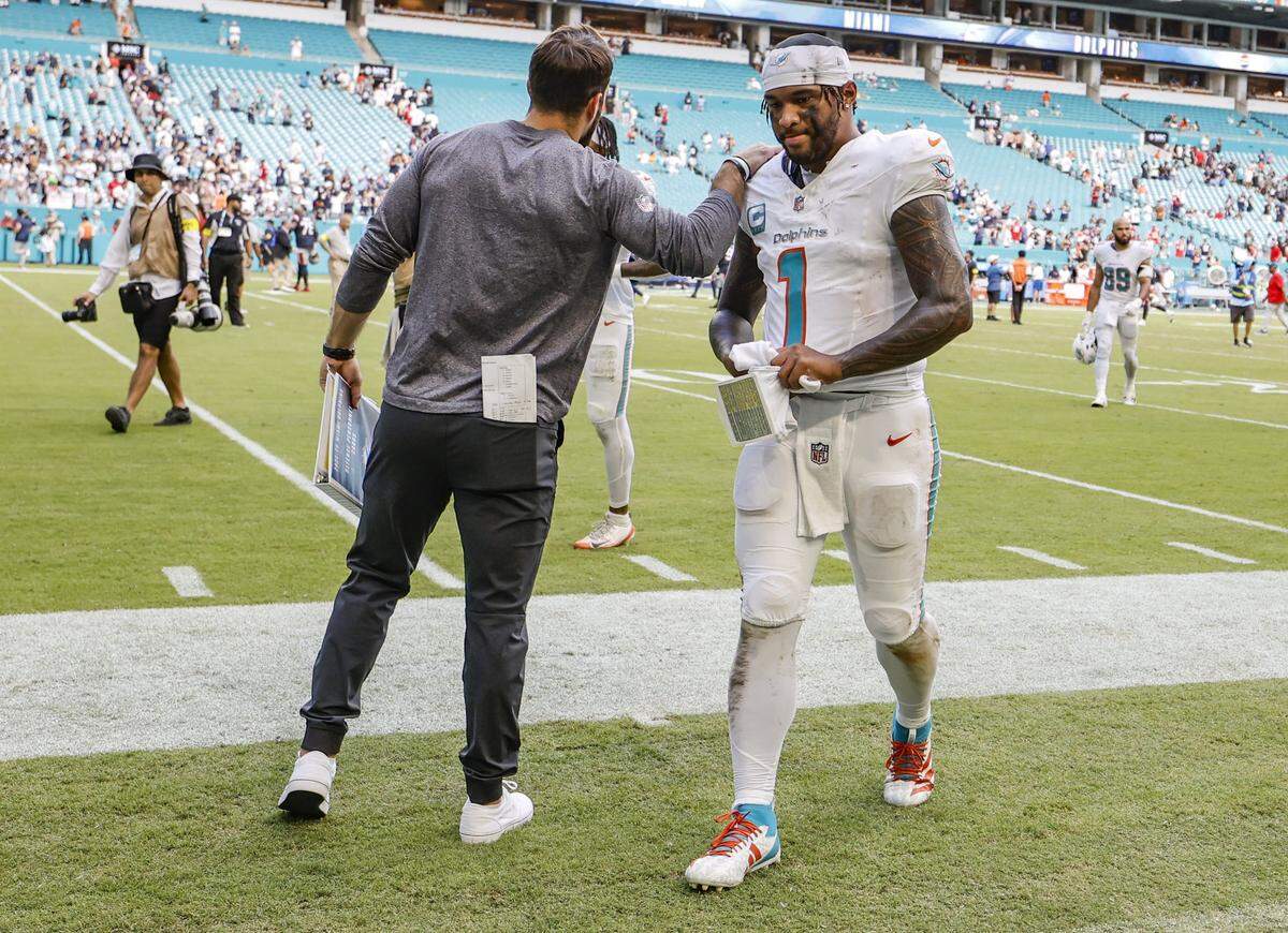 Miami Dolphins quarterback Tua Tagovailoa (1) walks off the field after the New England Patriots defeat the Dolphins during an NFL football game at Hard Rock Stadium in Miami Gardens, Florida, on Sunday, September 14, 2025.