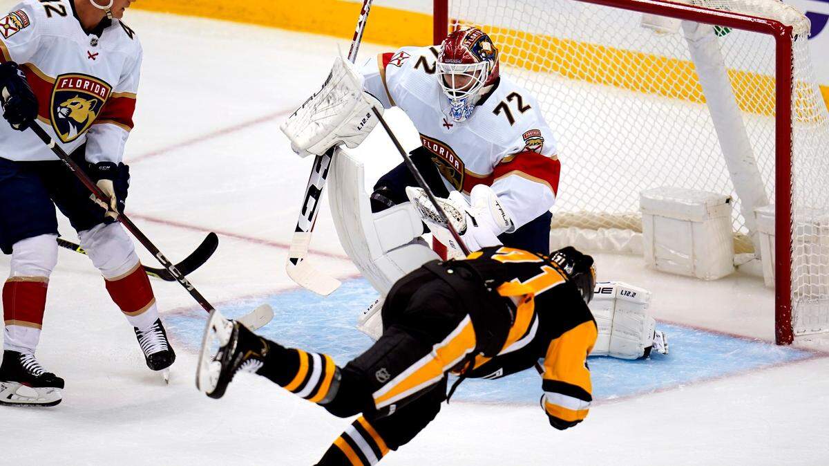 Pittsburgh Penguins’ Evgeni Malkin (71) falls as he attempts to get a shot off in front of Florida Panthers goaltender Sergei Bobrovsky (72) during the first period of an NHL hockey game in Pittsburgh, Tuesday, March 8, 2022. (AP Photo/Gene J. Puskar)