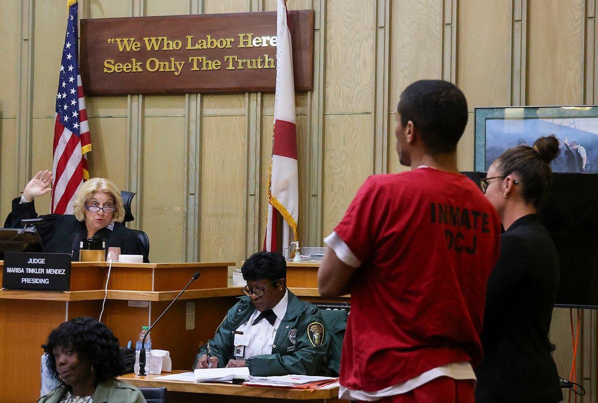 Judge Marisa Tinkler Mendez, left, swears-in Taji Pearson, 39, during a hearing in which he received a new sentence for his role in the shooting of a 15-year-old girl, on Wednesday, July 31, 2024, in Courtroom 4 - 6 at the Richard E. Gerstein Justice Building in Miami, Florida.
