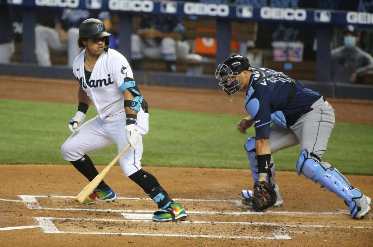 Miami Marlins catcher Jorge Alfaro (38) looks back at Tampa Bay Rays catcher Mike Zunino (10) after hitting a foul ball at loanDepot park in Miami on Thursday, April 1, 2021.
