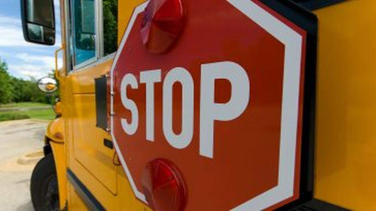 When a school bus Stop sign is extended, drivers going in both directions must comply.