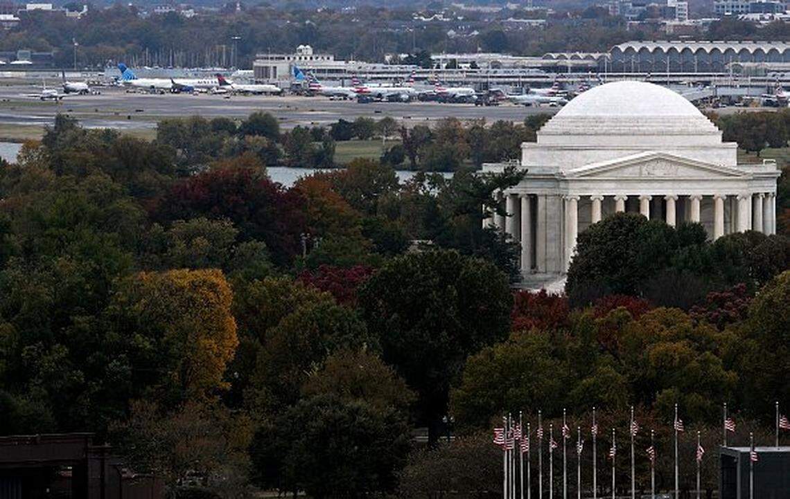 WASHINGTON, DC - OCTOBER 28: As the Thomas Jefferson Memorial is seen in the foreground, aircraft park at Ronald Reagan Washington National Airport on October 28, 2025 in Washington, DC. A nationwide staffing shortage of air traffic controller has led to many flight delays since the government shutdown on October 1. (Photo by Alex Wong/Getty Images)