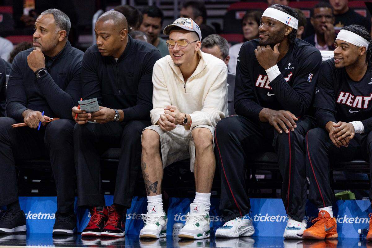 Miami Heat guard Tyler Herro (14) reacts from the sidelines during the first half of an NBA preseason game against the Milwaukee Bucks at Kaseya Center on Monday, October  6, 2025, in Miami, Fla.