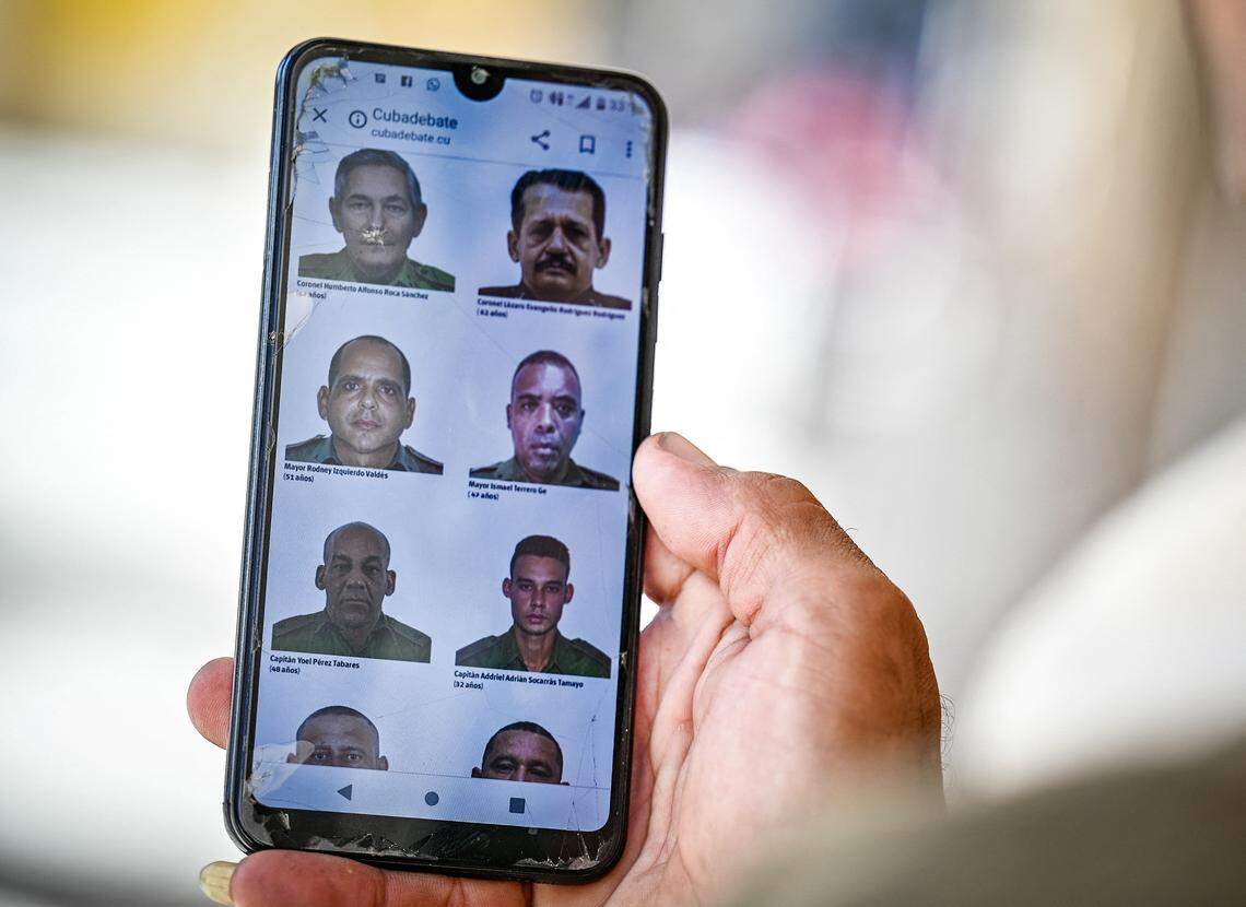 A man in Havana goes through the official website of the Cuban government cubadebate.cu on his mobile phone, which publish images of 32 Cuban officers and soldiers killed during the US military operation to capture Venezuela’s strongman Nicolás Maduro.