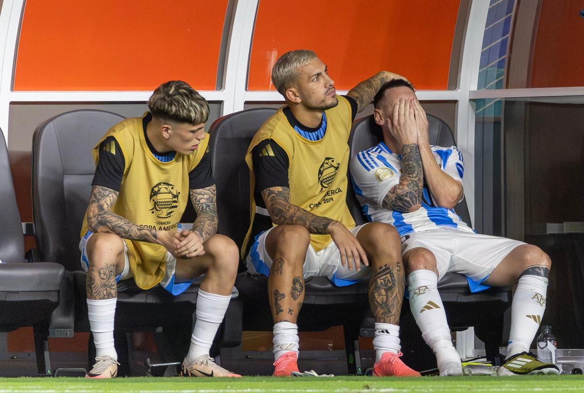 Argentina forward Lionel Messi (10) is comforted by teammate Leandro Paredes (5) after he was injured in a play against Colombia in the second half of the Copa America 2024 Final soccer match at Hard Rock Stadium on Sunday, July 14, 2024, in Miami Gardens, Fla.