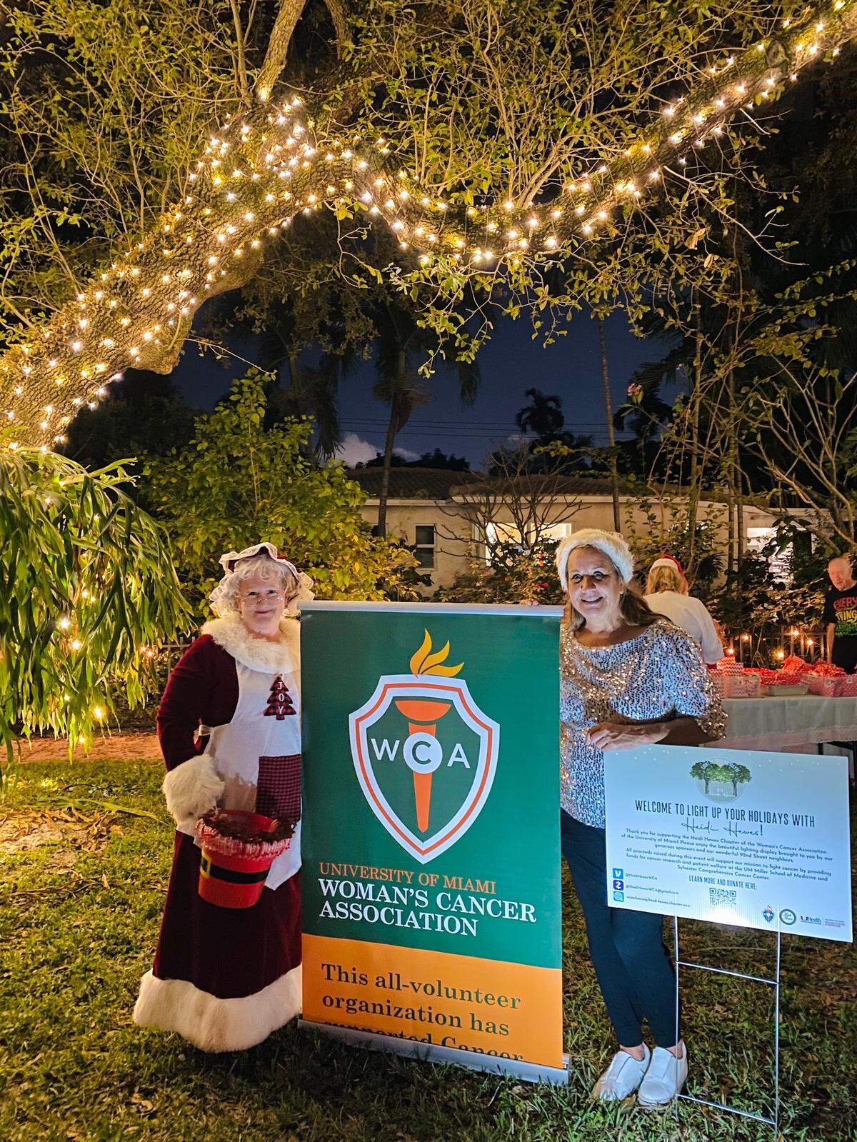 Ms. Claus, Elaine Asbury; and Nancy Cigno, president, Woman’s Cancer Association, celebrate holiday lights and generous fundraising at the annual event hosted by the Heidi Hewes Chapter of the Woman’s Cancer Association of the University of Miami.