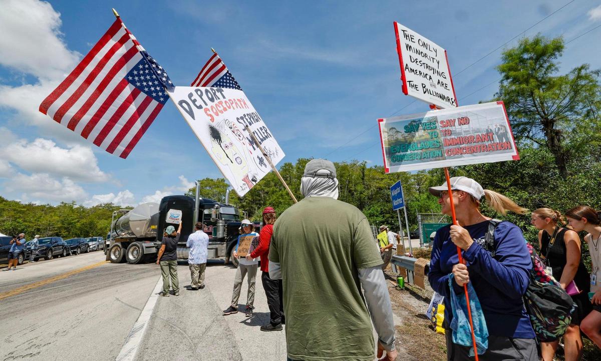 Protesters arrive at the front entrance as Florida lawmakers and members of Congress tour Alligator Alcatraz. The facility is within the Florida Everglades, 36 miles west of the central business district of Miami, in Collier County, Florida Saturday, July 12, 2025.