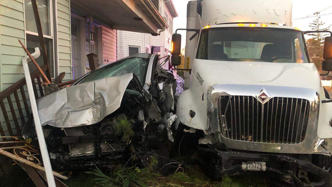 A neighborhood was left damaged, including cars, after a tractor-trailer driver swerved to avoid an animal in the road in Lynn, Massachusetts, officials said.