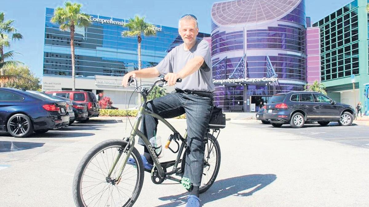 
Jay Versluis bikes to Mount Sinai Medical Center in Miami Beach, where Dr. Mike Cusnir, medical director of Mount Sinai’s Comprehensive Cancer Center, treated his colon cancer with immunotherapy. After nine months of infusions, Versluis has stopped the immunotherapy and has been clear of tumors since the end of 2017. Prior to this treatment, he was in a wheelchair with a grim prognosis.
