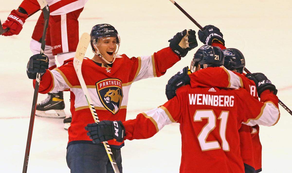 Florida Panthers Gustav Forsling (42) celebrates with Alex Wennberg (21) after Wennberg scored the winning goal in overtime as they defeat the Detroit Red Wings at the BB&T Center in Sunrise, Florida, Thursday, April 1, 2021.