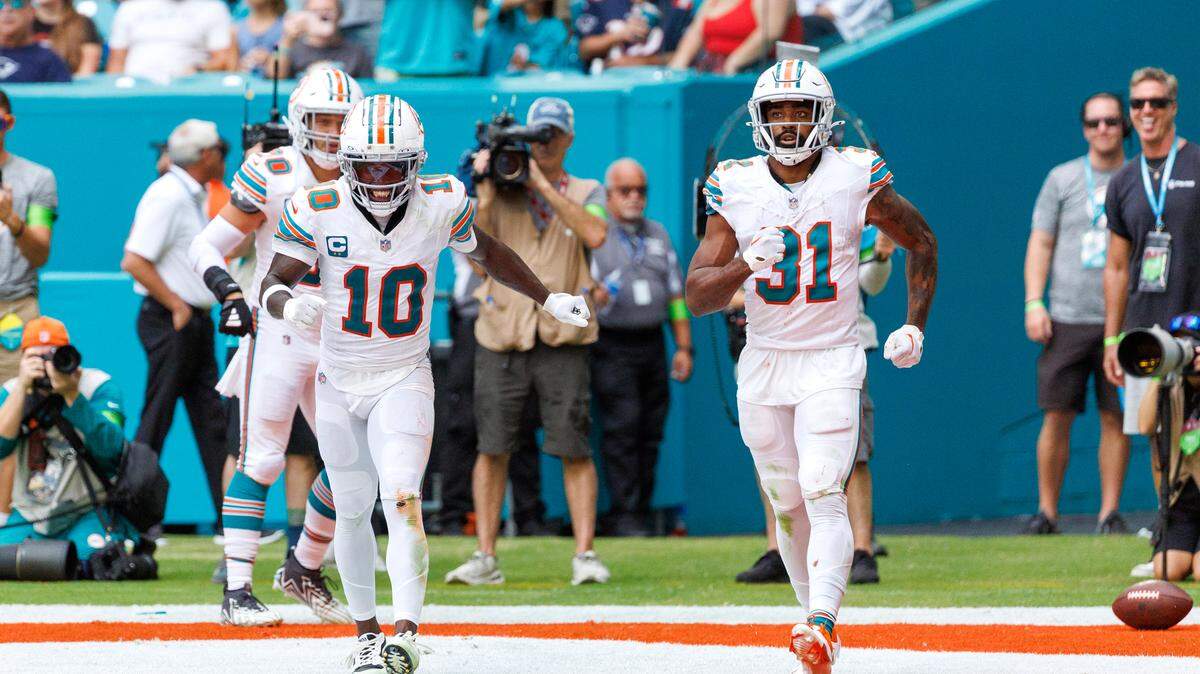 Miami Dolphins running back Raheem Mostert (31) celebrates with teammate Tyreek Hill (10) after a scoring a touchdown during third quarter of an NFL football game against the New England Patriots at Hard Rock Stadium on Sunday, Oct. 29, 2023 in Miami Gardens, Fl.