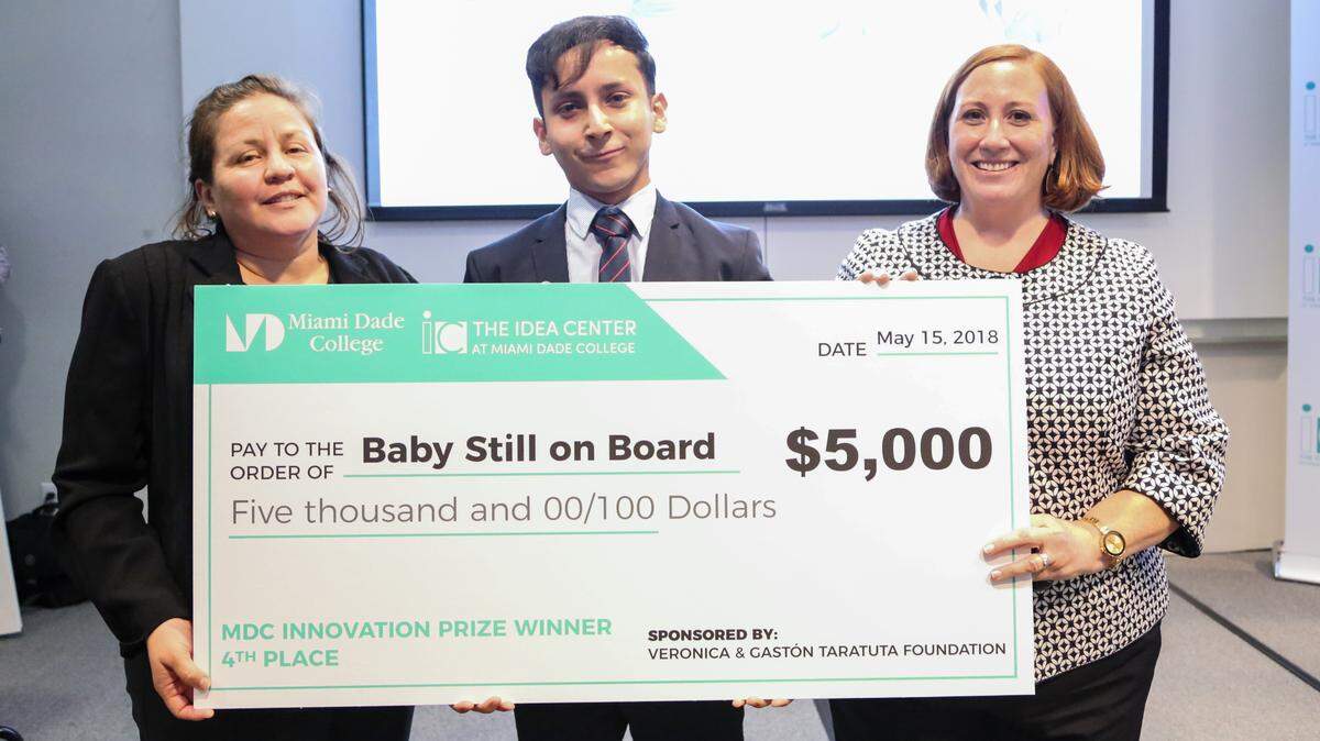 Brizeyda Constantiny, left, and Bruno Shagun, co-founders of Baby Still on Board, pose with their Innovation Prize along with  Pamela Santos, director of Innovation & Entrepreneurship Programs at Miami Dade College’s Idea Center on July 10, 2018.