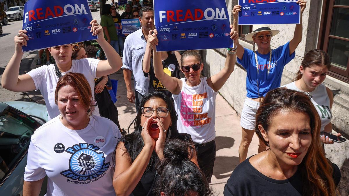 Karla Hernandez-Mats, president of United Teachers of Dade, center, leads in chanting slogans against book banning as marchers arrive at Book & Books during the “Walk for Freadom” kickoff event on Oct. 1 in Coral Gables. 