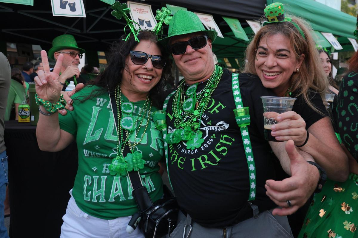 Magda Garay, left, Tony Garay, center, and Jackie Garcia, right, pose for a photo while enjoying the John Martin’s 32nd Annual St. Patrick’s Day Street Festival in Coral Gables, Florida, Saturday, March 15, 2025.