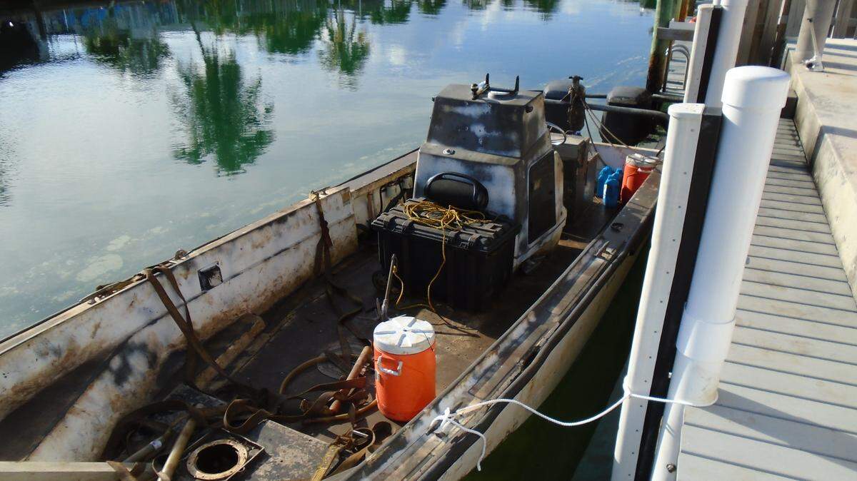 A charred Boston Whaler center console boat is docked behind a residence in Key Colony Beach, a small, incorporated community in the Middle Florida Keys. The vessel caught fire Thursday morning, April, 8, 2021.