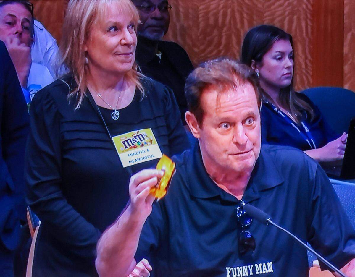 Nathan Kurland holds up a bag of M&Ms during his remarks at the City of Miami Commission meeting on Thursday, Oct.24, 2024, at City Hall in Miami. Public comments were heard on the controversial pension plan first co-sponsored by Commissioners Miguel Angel Gabela and Christine King.