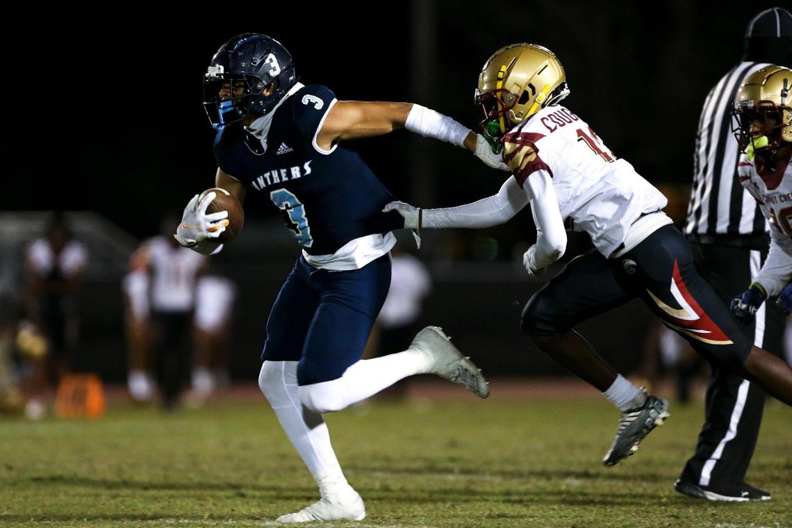 Palmetto Panthers wide receiver Derrick Bohler (3) runs with the football ahead of Coconut Creek Cougars cornerback Jeano Robinson (12) during the fourth quarter at Miami Southridge Senior High School in South Miami, Florida, Thursday, November 3, 2022.