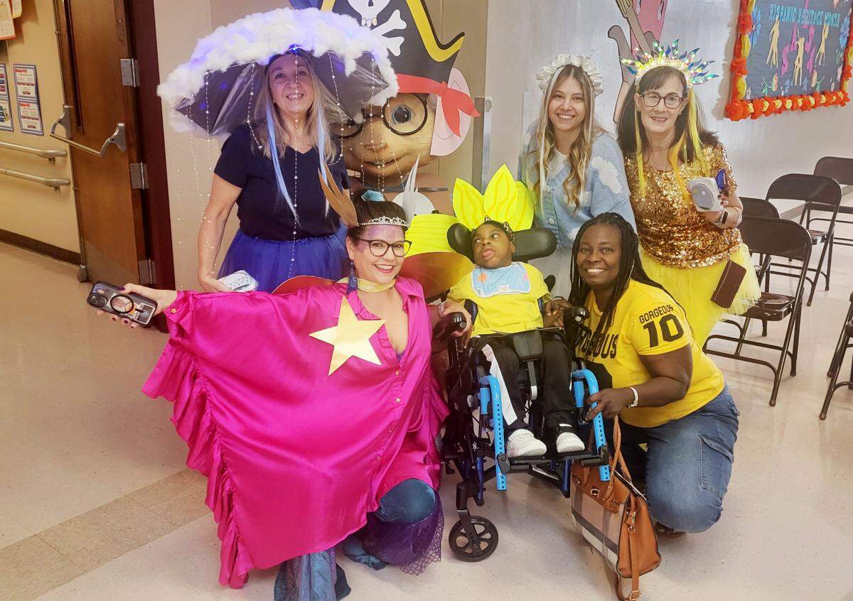 From left: Leo Alcindor, center; and Natacha Sinvil, Leo’s aunt, wearing a yellow T-shirt, during the Book Character Parade at Bright Horizon School in Pompano Beach.
