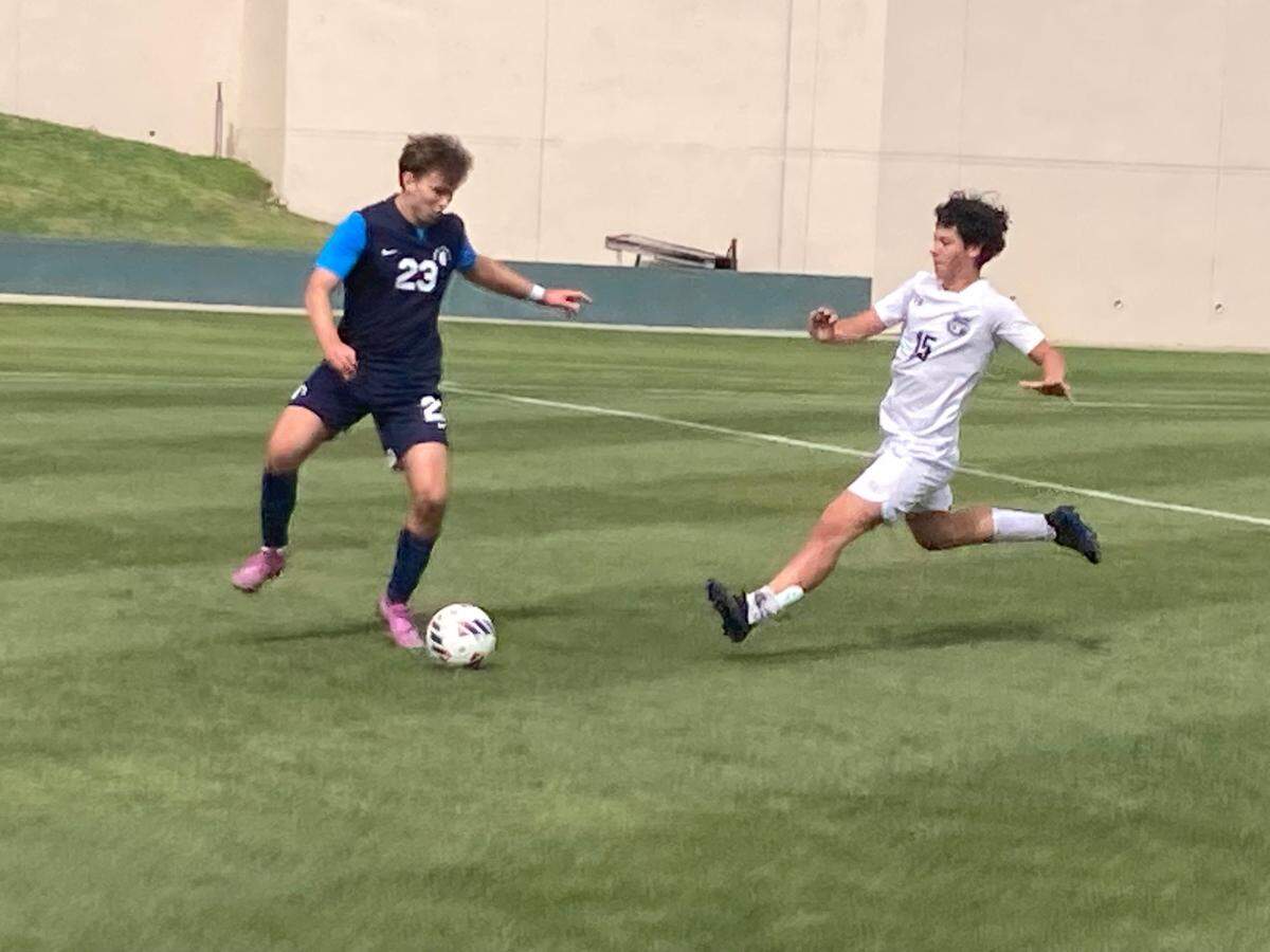 Gulliver’s Ryan Fischer outraces a Delray American Heritage defender to a loose ball during Tuesday’s Class 3A boys’ soccer state semifinal at Spec Martin Stadium in DeLand, Fla.