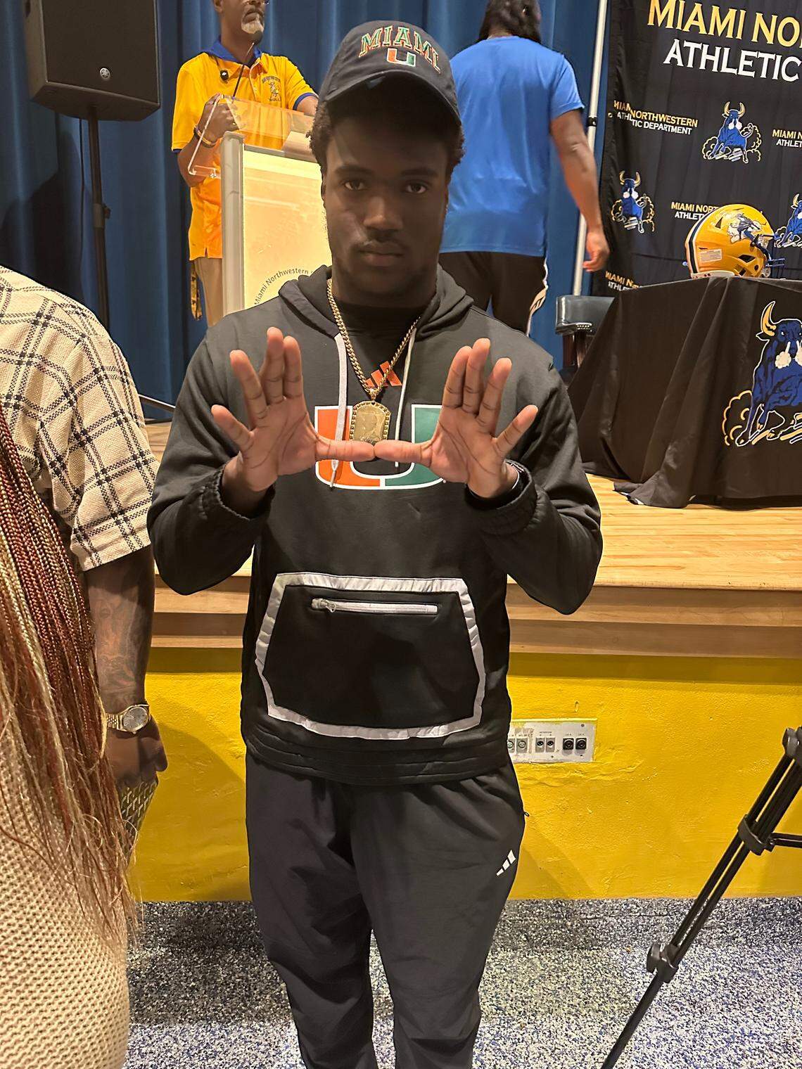 Miami Northwestern’s Jordan Campbell throws up The U after formally signing with the Miami Hurricanes on Wednesday, Dec. 3, 2025.