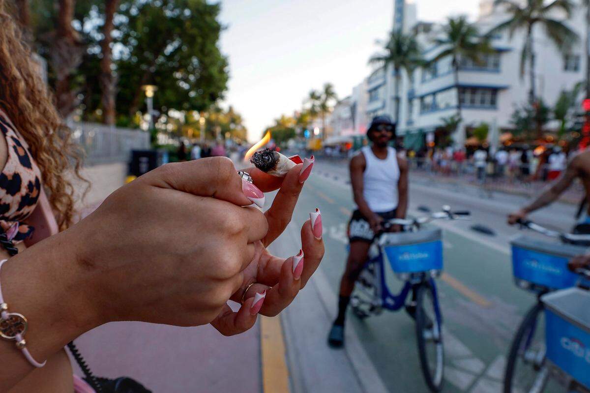 Crista lights up a marijuana cigarette during Spring Break along Ocean Drive, Miami Beach, Florida on Friday, March 14, 2025.