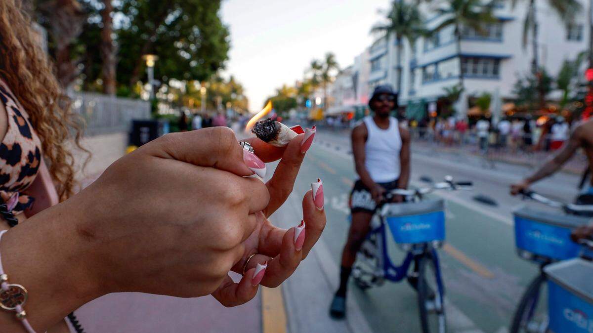 Crista lights up a marijuana cigarette during Spring Break along Ocean Drive, Miami Beach, Florida on Friday, March 14, 2025. 