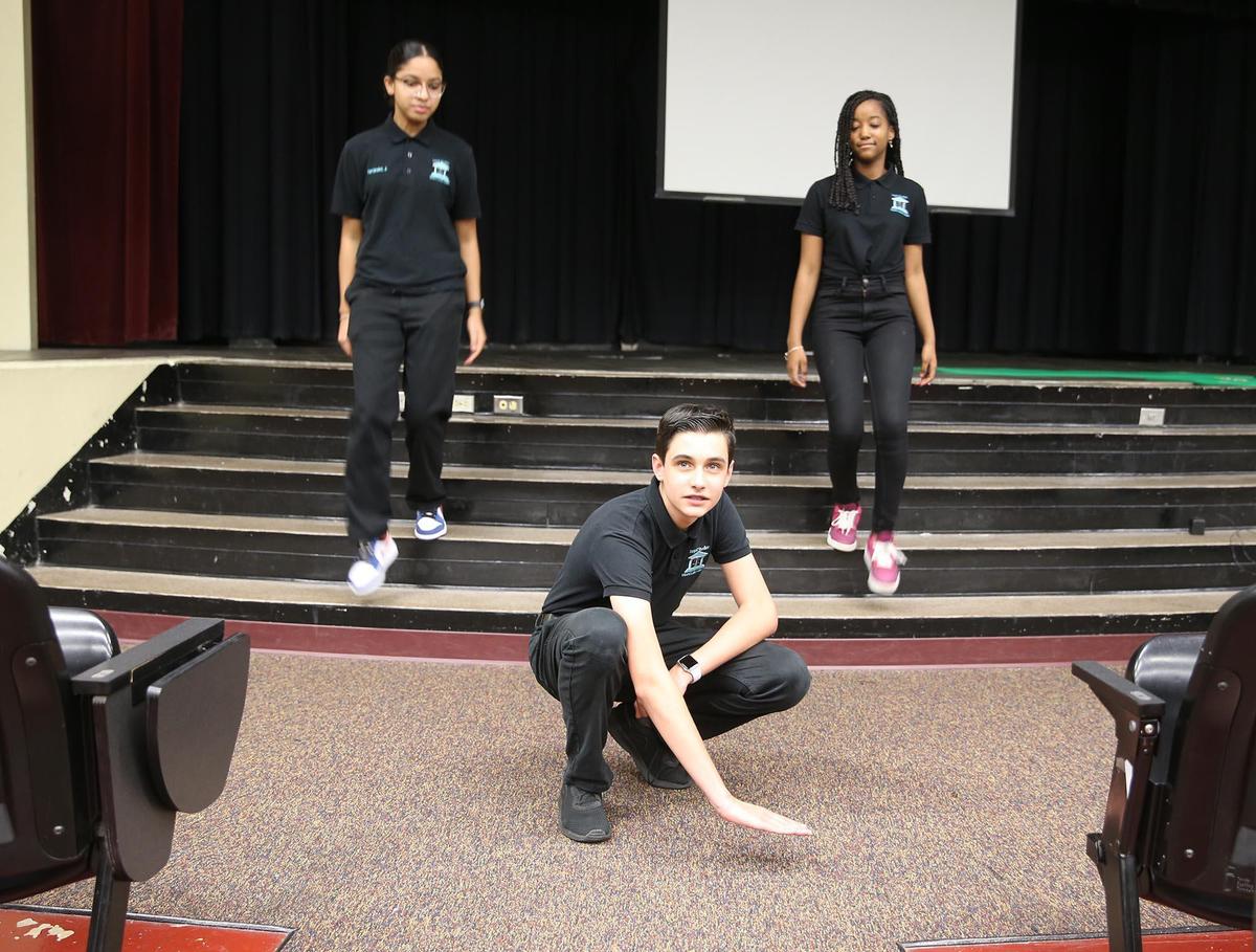 Maurits Acosta, pictured here in June of 2021, was in seventh grade when he and classmates Jocelyn Hernandez and Gabriella Vega from Miami Lakes Middle School proposed flood prevention legislation to the town council after Tropical Storm Eta flooded parts of the west Miami-Dade town, including their school auditorium. Here he is gesturing to show how high the flood water was.