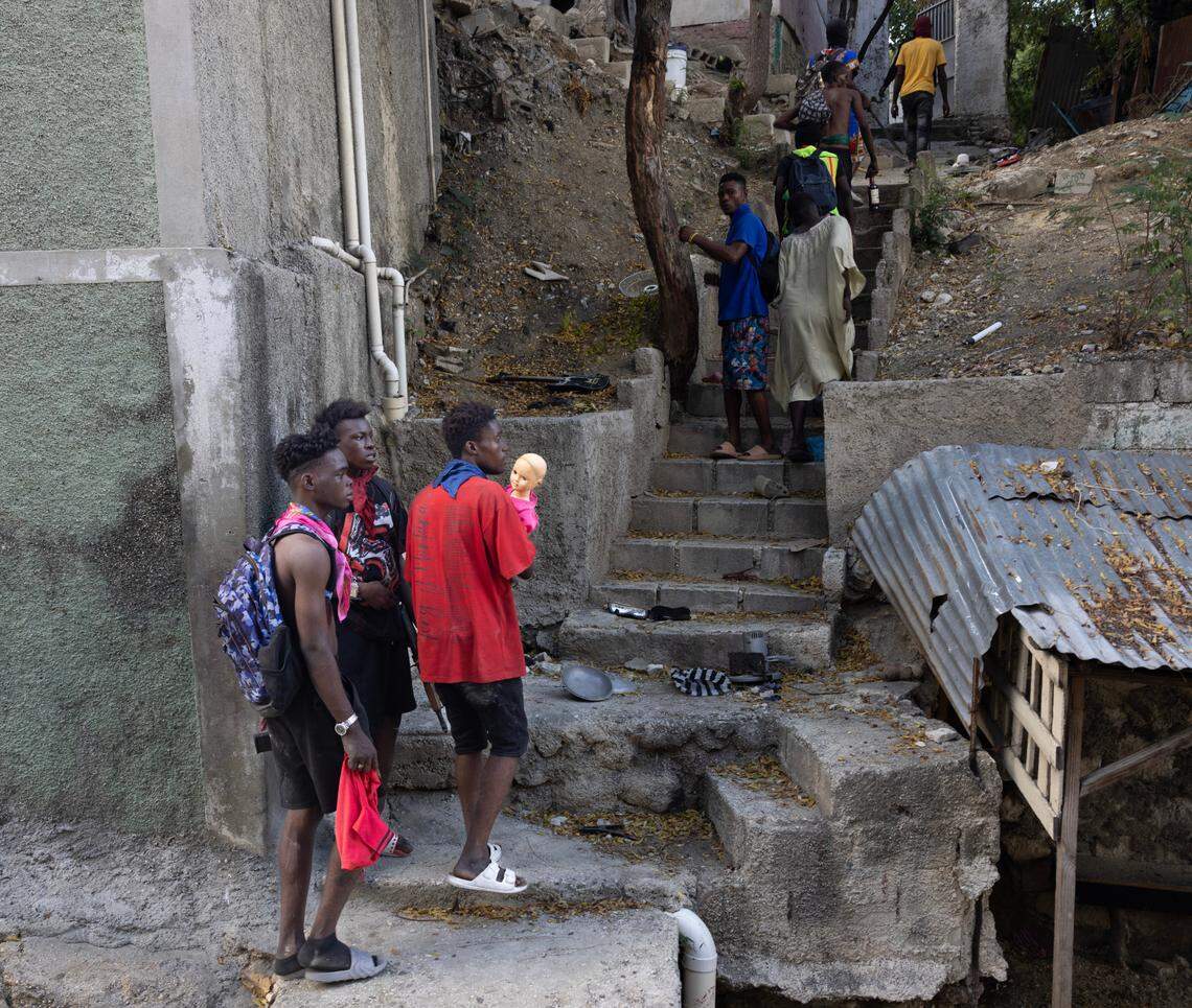Gang members carrying a doll they picked up during a day-long raid in Port-au-Prince on Dec. 9, 2024.