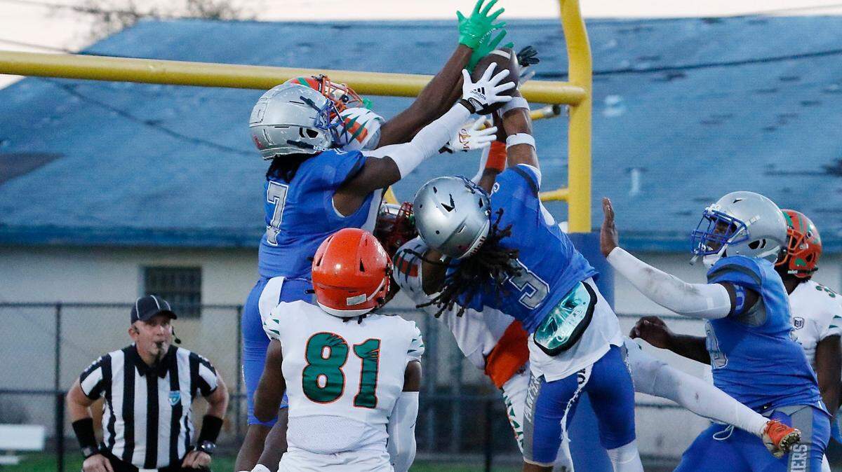 Blanche Ely Tigers and Dillard Panthers battle for a pass during football playoff game on Saturday, November 19, 2022 at Dillard HS in Fort Lauderdale. Andrew Uloza / for Miami Herald
