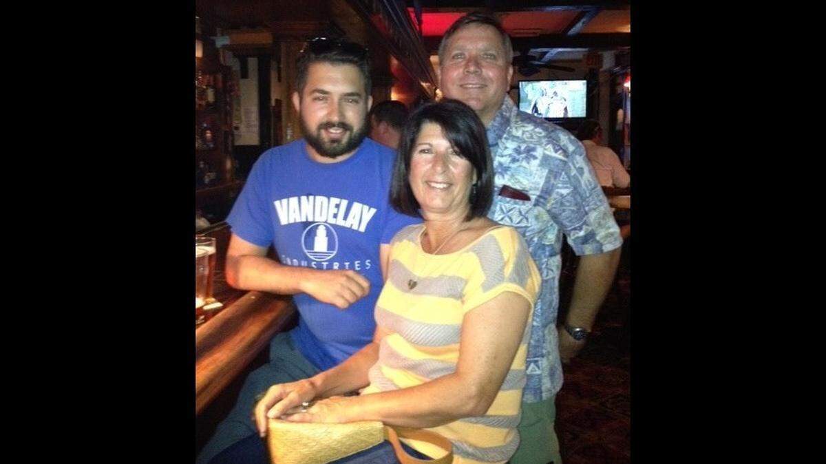 Justin Waldron, left, with his stepfather Stephen Stokes and mother Maryann Stokes in an undated photo.