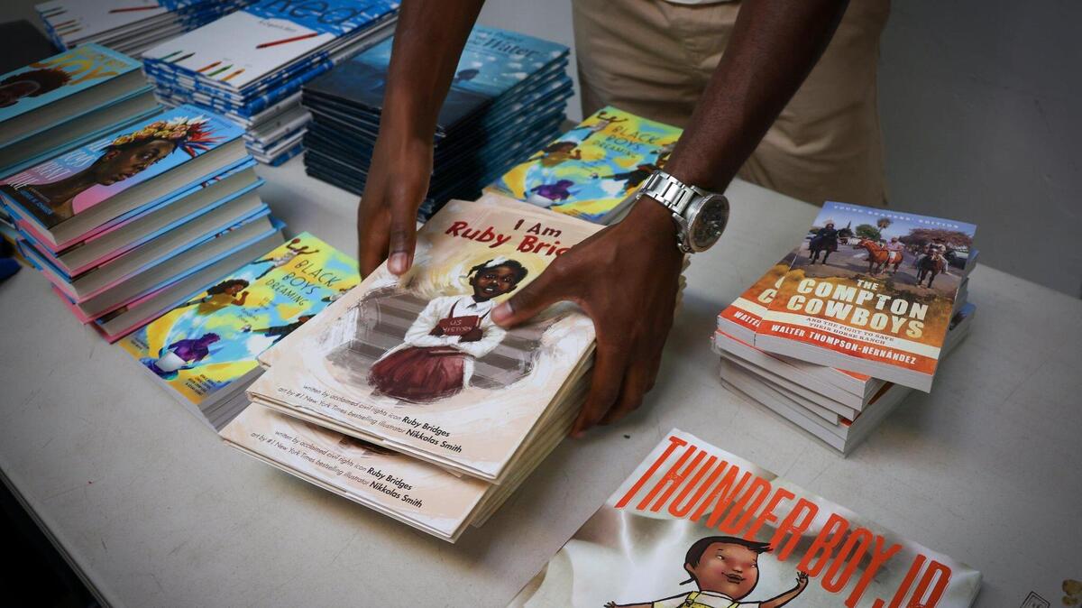 Chicago resident and TJC Freedom Rider, Edward Ward, on June 22 distributes banned books at Mt. Olive Missionary Baptist Church, where national and local activists gathered to confront the anti-woke agenda by Florida governor and presidential candidate Ron DeSantis.